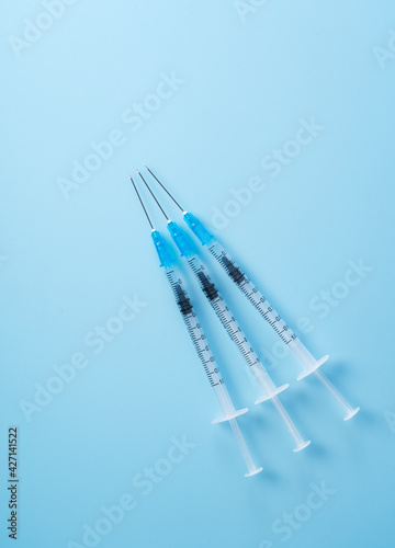 Syringes placed on a blue background