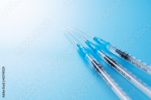 Syringes placed on a blue background