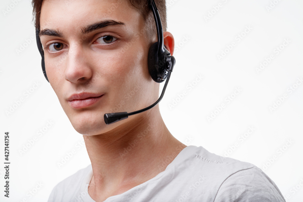 Cropped portrait of a young man wearing a headset looking at cam Cropped portrait of a young man wearing a headset looking at cam