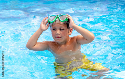 young boy in swim goggles