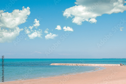 Beautiful landscape with white sand beach. Panoramic view on blue sky and azure coast sea on natural background. Luxury summer vacation