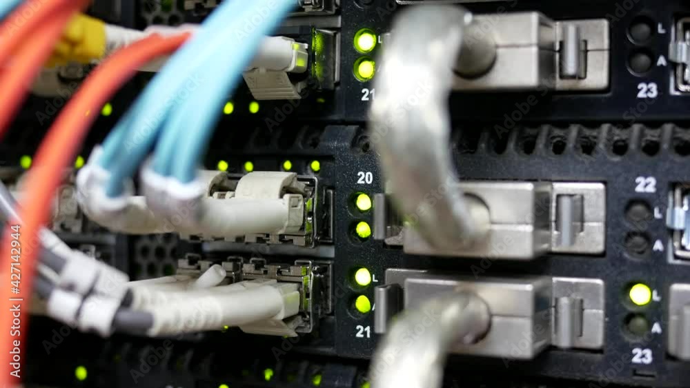 fiber optic cable network connected to internet switch servers in data center.