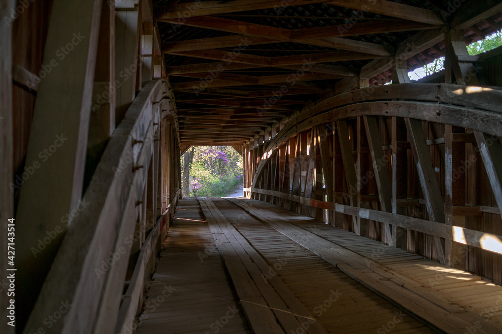 Inside a long wooden covered bridge, as we drive through this vintage building