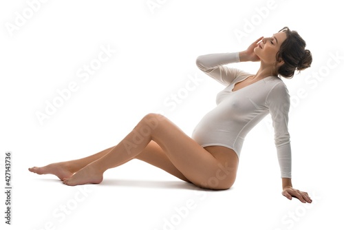 Graceful pregnant woman in bodysuit relax in studio © Wisky