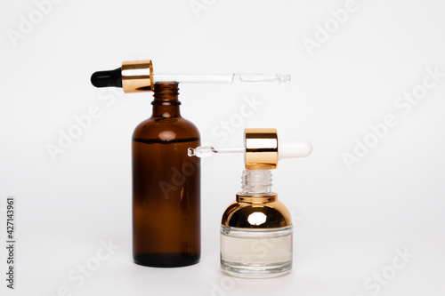 Amber glass bottles with pipette. Transparent hyaluronic gel and oil skin care concept. Top horizontal view copyspace