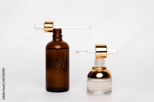 Amber glass bottles with pipette. Transparent hyaluronic gel and oil skin care concept. Top horizontal view copyspace