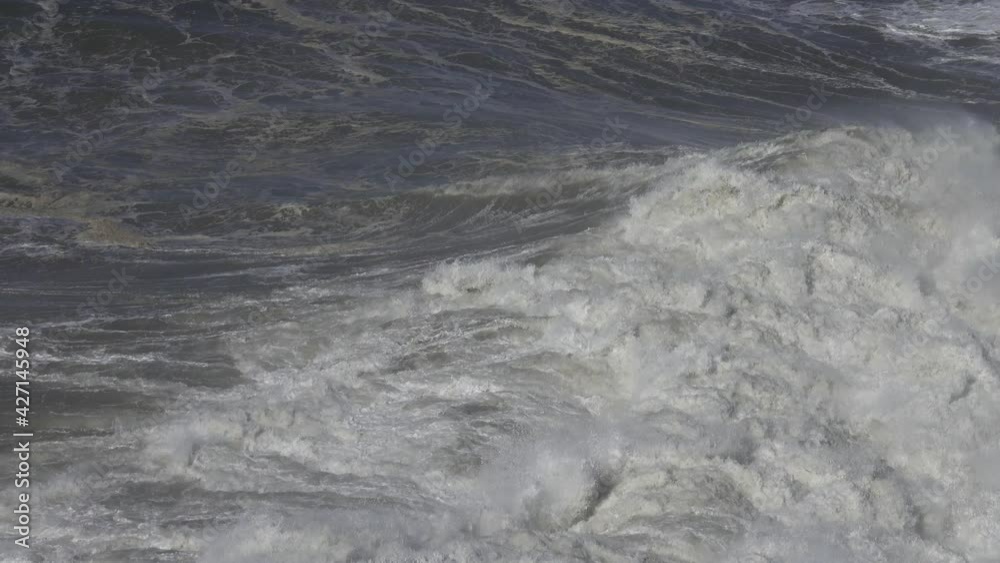 Large foamy wave rolling on the surface of a stormy ocean, 4k Large foamy wave rolling on the surface of a stormy ocean, 4k