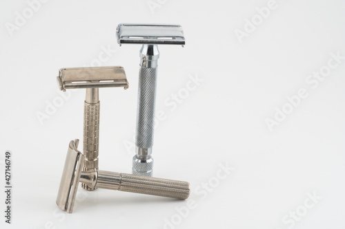 Vintage double edge safety razor for shaving, metal, nickle, and chrome. On white isolated background
