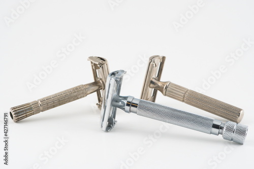 Vintage double edge safety razor for shaving, metal, nickle, and chrome. On white isolated background