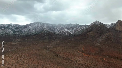 Desert Flyover with Snow Covered Mountains