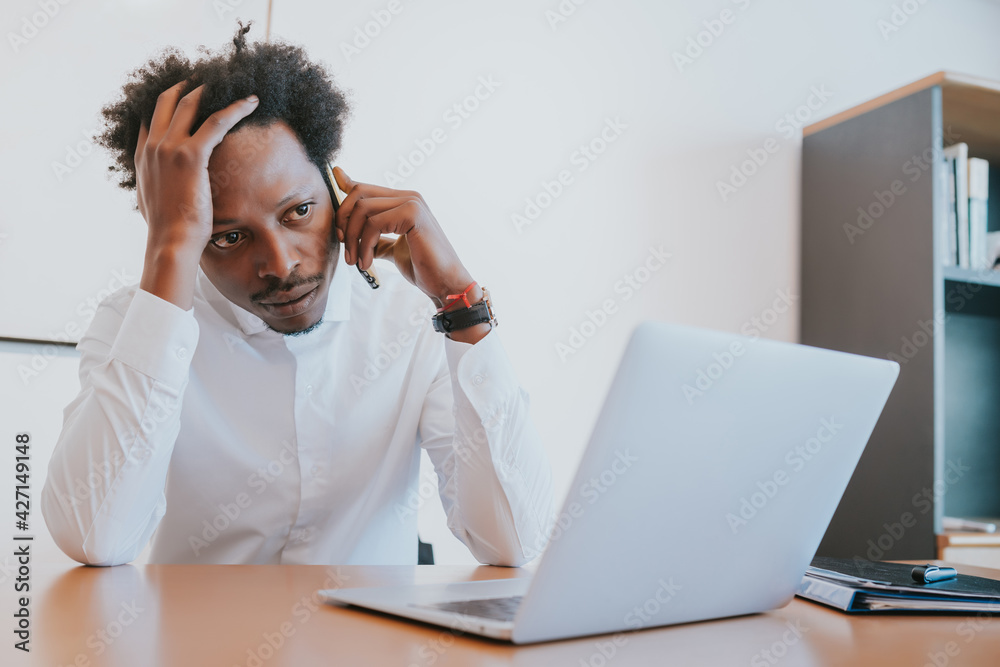 Businessman talking on phone at office. Businessman talking on phone at office.