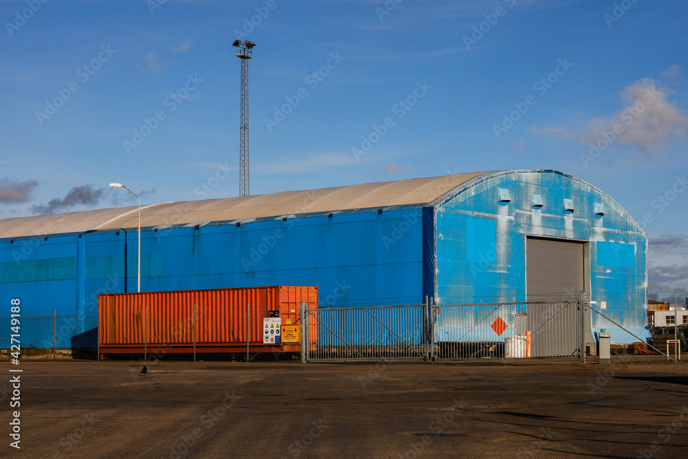 Halmstad, Sweden, A warehouse building in the harbour and orange container.