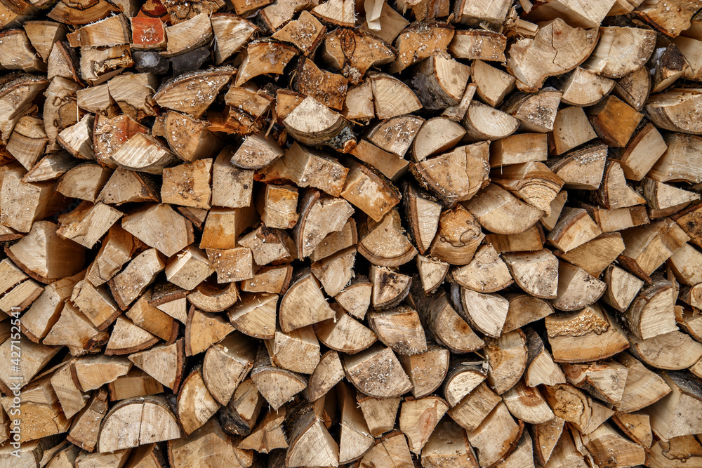 Split logs are stacked in smooth pile of firewood Split logs are stacked in smooth pile of firewood