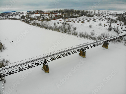 Aerial view of the railway bridge over the Cheptsa river in winter (Kirovo-Chepetsk, Kirov region, Russia) photo