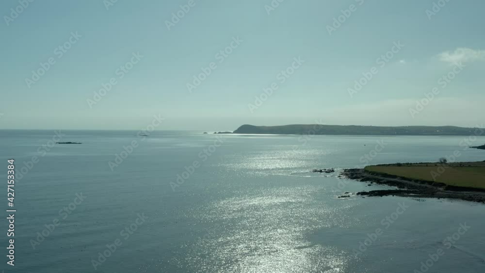 Wide angle dolly in aerial birds eye view of ocean coast during summer day Wide angle dolly in aerial birds eye view of ocean coast during summer day