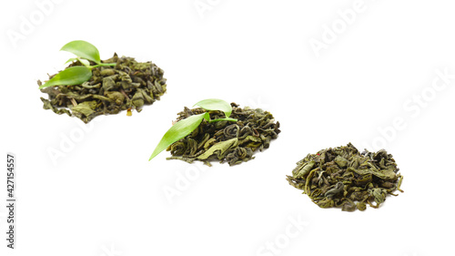 Heaps of dry green tea on white background