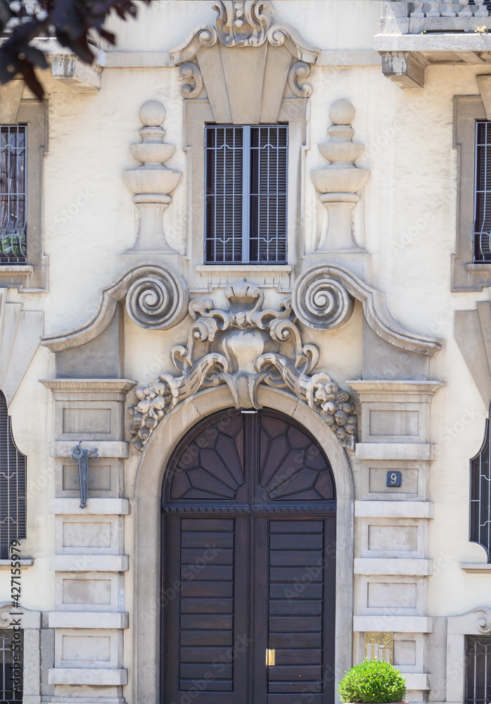 Characteristic architecture of an ancient palace with elegant facade decorations.Milan, Lombardy, Italy.