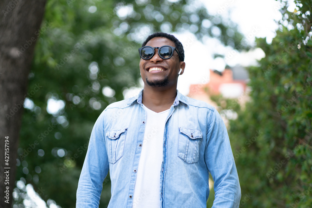 Man smiling while standing outdoors. Man smiling while standing outdoors.