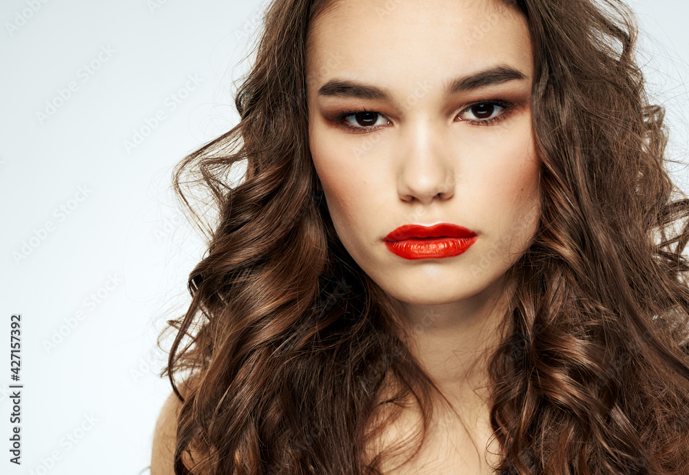 Portrait of a beautiful woman with red lips and curly hair at the barbershop Portrait of a beautiful woman with red lips and curly hair at the barbershop
