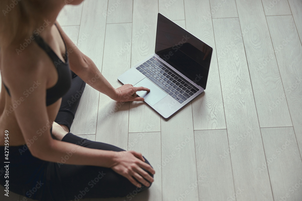 Fototapeta premium Caucasian beautiful woman is doing sports at cozy apartment