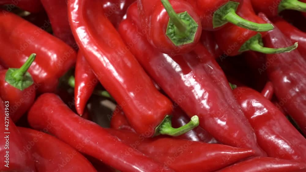 Red paprika bell pepper background. Fresh sweet pepper paprika on the counter of a vegetable market. Farm vegetables. Red paprika bell pepper background. Fresh sweet pepper paprika on the counter of a vegetable market. Farm vegetables.