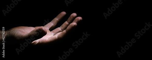 asking hands of a working man in the dark