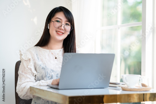 Free Download Happy of asian freelance people Businesswoman wearing wireless earphones casual working with laptop computer with a coffee cup mug,Notebook and smartphone at the cafe,Business Lifestyle communication - GFXLoad