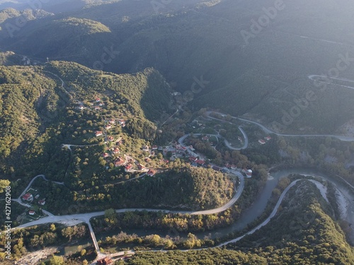 Aerial Shot Of Vrosina Traditional  Village Municipality Of Zitsa, In Ioannina Greece, Epirus. The Village Crosses The River Kalamas With The Famous Traditional Stone Bridge photo