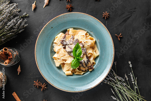 Top view on pappardelle with mushrooms and parmesan cheese