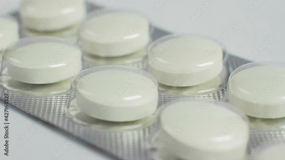 Pack of pills isolated on white background, macro closeup rotation Pack of pills isolated on white background, macro closeup rotation