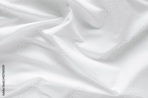 Abstract white fabric texture background. Cloth soft wave. Creases of satin, silk, and cotton.