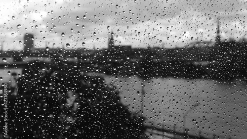 Black and white photo of Riga through glass with raindrops