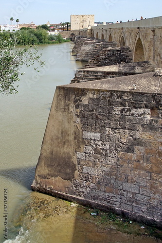 View of the Roman Bridge, a stone bridge that spans the river Guadalquivir. photo