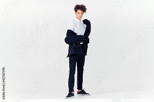 business man in suit and curly hair emotions light background fashion