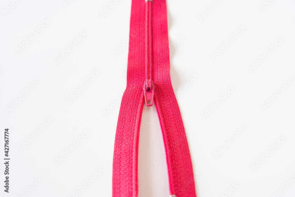 half open pink zipper. Selective Focus. isolated Ehite Background half open pink zipper. Selective Focus. isolated Ehite Background