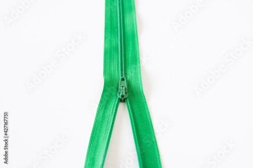 half open green zipper. Selective Focus. isolated White Background