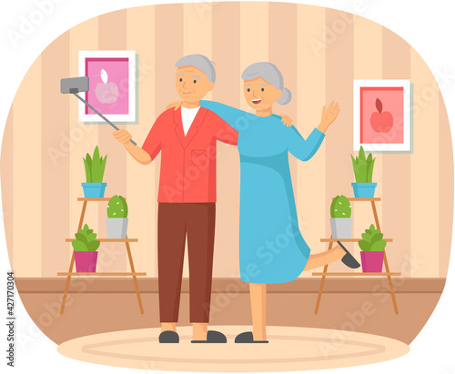 Elderly couple standing with monopod against background of window and making photo together on phone
