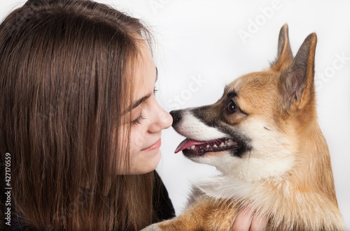 Caucasian teenage girl with corgi dog puppy