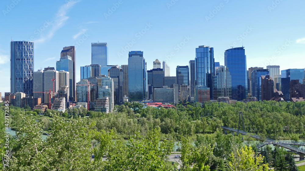 Calgary city centre with tall skyscrapers aerial panoramic view, cityscape surrounded by river and green parks, Alberta, Canada