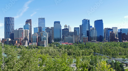 Calgary city centre with tall skyscrapers aerial panoramic view, cityscape surrounded by river and green parks, Alberta, Canada © Milan