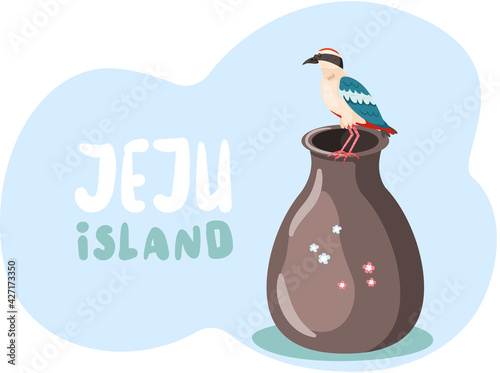 Exotic bird sits on clay jug and Jeju island inscription in blue. National pitta nymfa on pottery photo