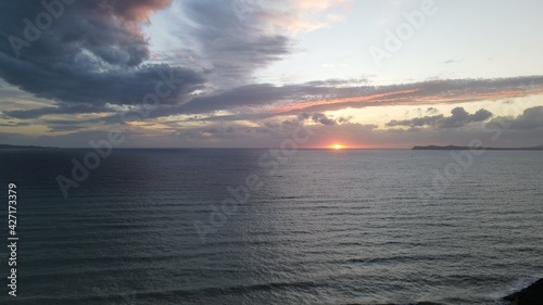 colorful sunset sky and horizon and clouds, in karavostasi beach of perdika in epirus, greece © tassos stavrou