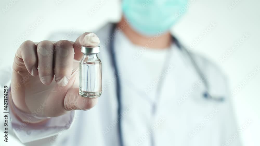 Doctor In Gloves Holding Syringe And Vaccine Doctor In Gloves Holding Syringe And Vaccine