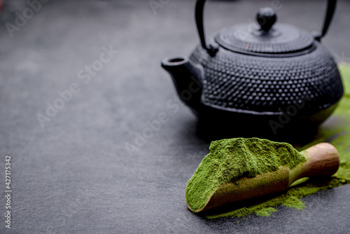 Plakat Powdered green tea and set for matcha on black background