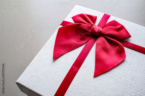 Valentine present. Gift box and red ribbon for romantic couple.Gift box and ribbon with tag for valentine present