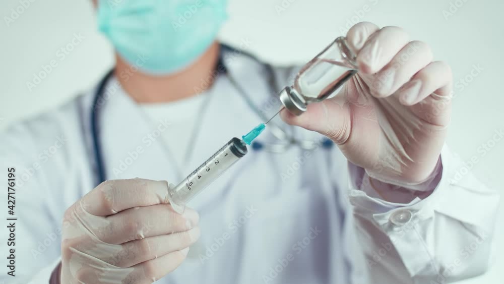 Doctor Hand Holding A Syringe With Liquid Vaccines Doctor Hand Holding A Syringe With Liquid Vaccines