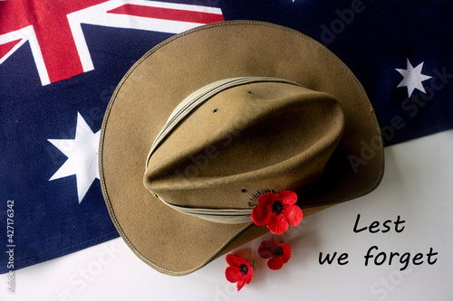 Tela Royal Australian Air Force RAAF diggers slouch hat with blue trim to show area of service against an Australian flag with red poppies for Anzac Day and Remembrance Day