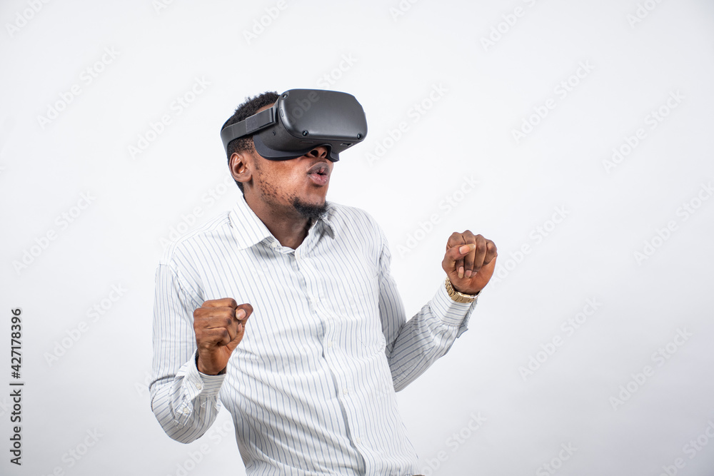 young nigerian man using a virtual reality head set young nigerian man using a virtual reality head set