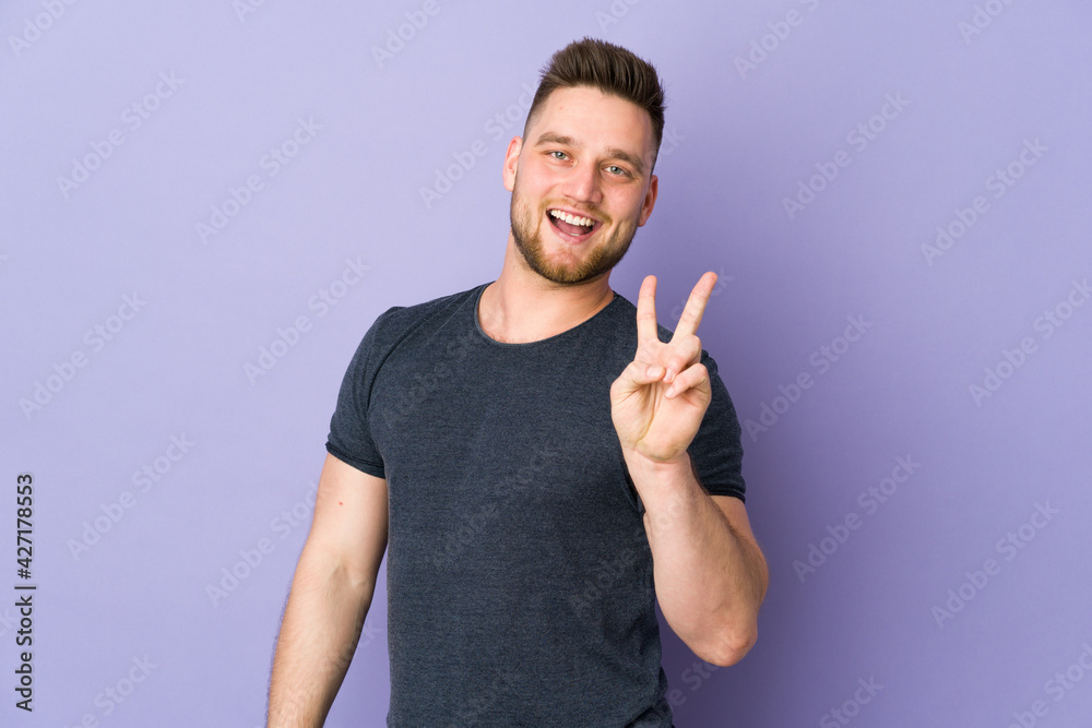 Russian handsome man over isolated background smiling and showing victory sign Russian handsome man over isolated background smiling and showing victory sign