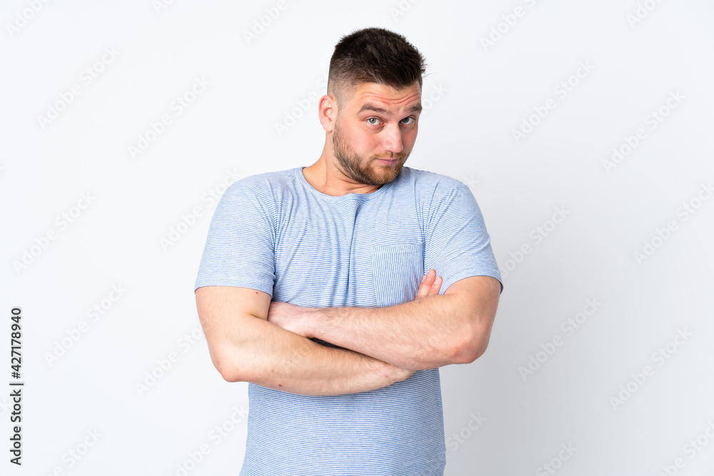 Russian handsome man over isolated background making doubts gesture while lifting the shoulders Russian handsome man over isolated background making doubts gesture while lifting the shoulders